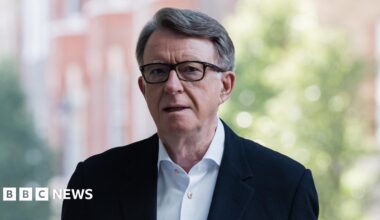 Lord Mandelson pictured outside wearing a blue shirt and dark blazer.