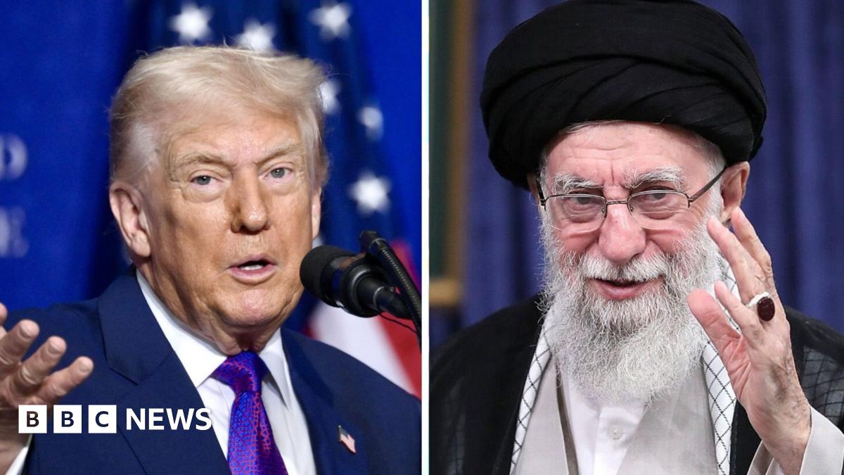 Two women and a man walk past a billboard showing an artistic impression of clouds in the red, white and blue colours of the US flag. Slogans appear on the billboard in Farsi and English.