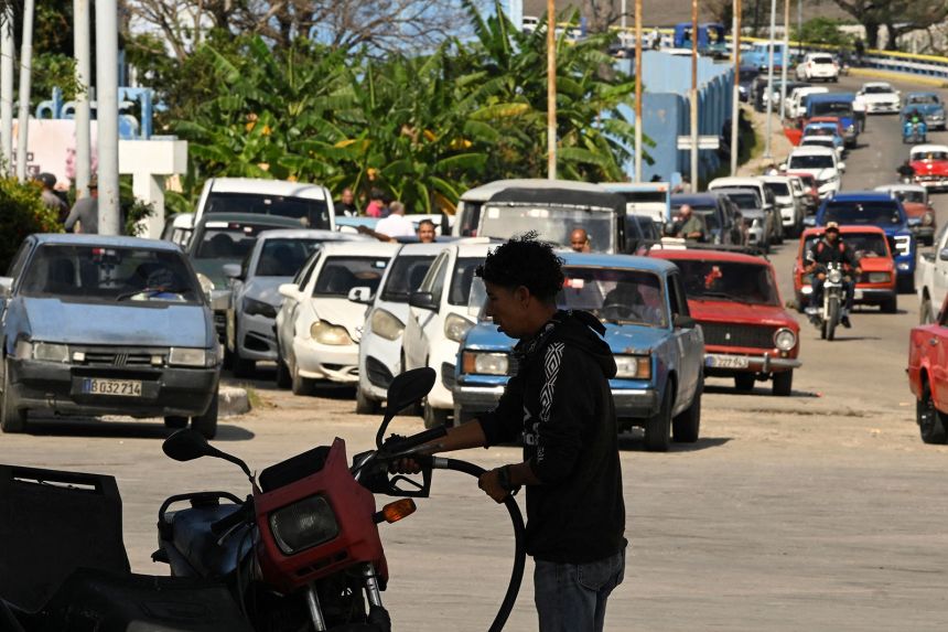 A driver fills up his tank at a gas station as Cuban President Miguel Diaz-Canel announces his government will roll out a plan in the next week to confront fuel shortages as the US moves to block the supply of oil, in Havana, Cuba, on February 5, 2026.