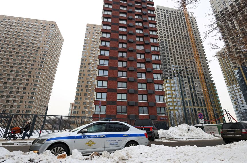 A police car is parked outside the residential building where the shooting took place in Moscow early on Friday morning.