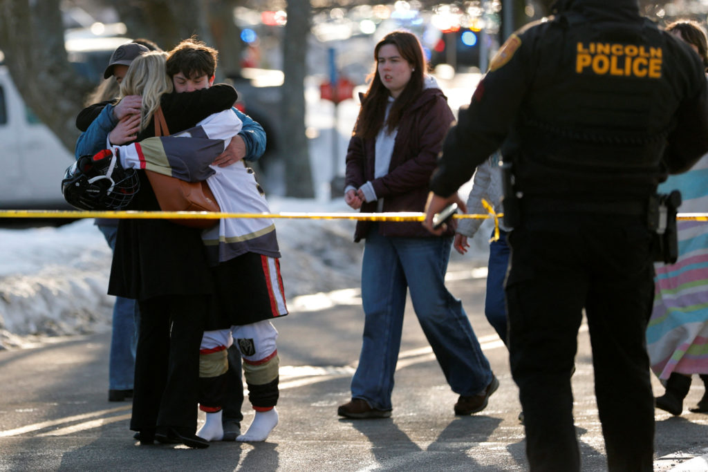 Police and emergency vehicles are seen outside the Dennis M Lynch Arena, an indoor ice skating rink, after a shooting in P...