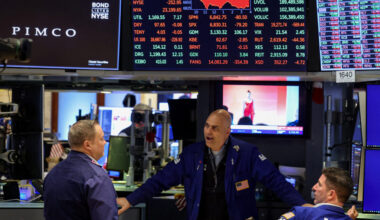 Traders work on the floor of the NYSE in New York