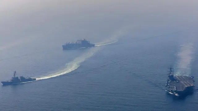 USS Abraham Lincoln (far-right) seen in the Arabian Sea with two other ships of its carrier strike group
