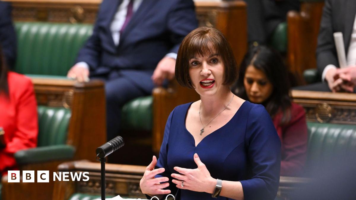 Bridget Phillipson speaks at a dispatch box in the House of Commons, with notes and microphones in front of her. Other attendees sit on the green benches, observing the proceedings.