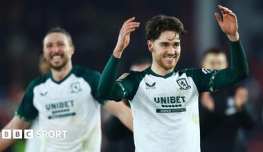 Hayden Hackney (to the forefront on the right) with his arms aloft and a big smile after Middlesbrough's win at Sheffield United with Luke Ayling (behind him in the background on the left)