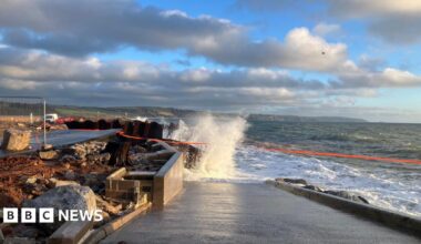 A wave crashes into the partially collapsed A379 Slapton Line between Torcross and Slapton.