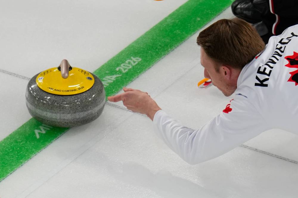 Canada’s Marc Kennedy delivers the stone during a men’s curling round robin match against China at the 2026 Winter Olympics, in Cortina d’Ampezzo, Italy, on Sunday. (David J. Phillip / The Associated Press)