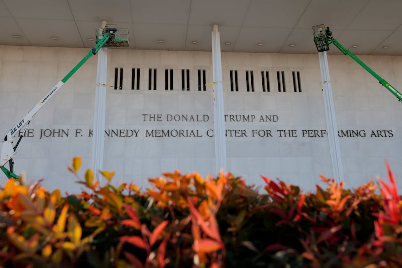 Workers adjust the name of the “John F. Kennedy Memorial Center for the Performing Arts"