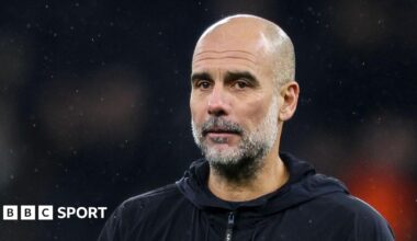 Pep Guardiola walks across the pitch