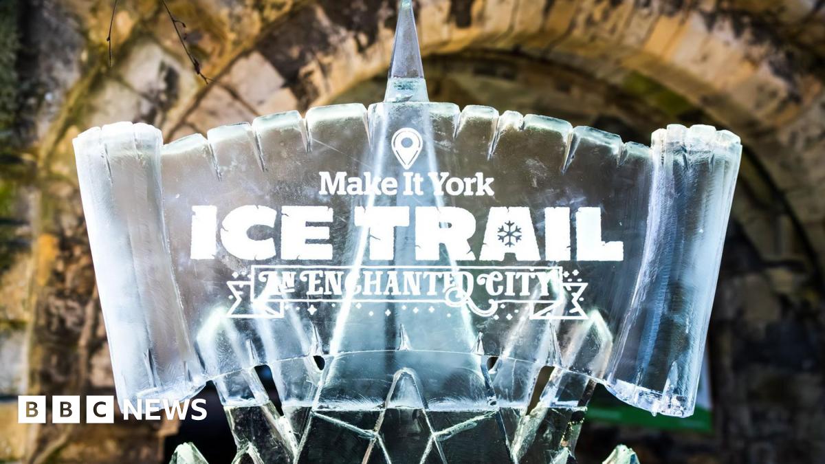 A sign carved from ice with the words Make it York Ice Trail An Enchanted City carved into the sign