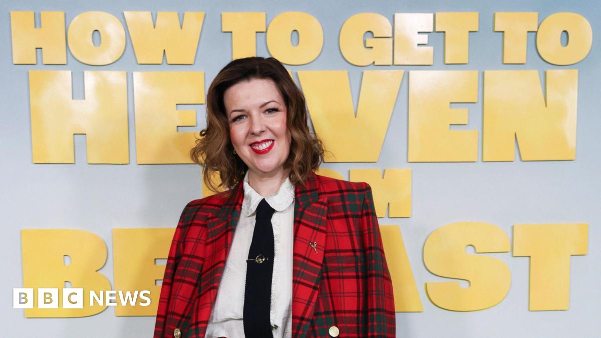 Six woman stand and look to the camera. They stand in front of a promo board which has the title 'How to get to heaven from Belfast' on it in yellow font.