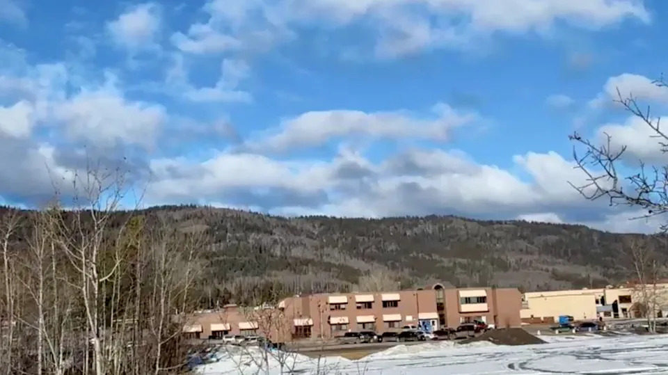 Vehicles are parked outside the Tumbler Ridge Secondary School, the site of a deadly mass shooting in Tumbler Ridge, British Columbia, Canada, February 10, 2026, in this screengrab obtained from a social media video. Trent Ernst/Tumbler RidgeLines/via REUTERS
