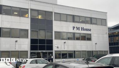 A sheet of white paper taped to the inside of a glass door or window. The notice is printed in large text at the top with the heading “IMPORTANT NOTICE”, followed by smaller text explaining that, due to regulatory matters, the businesses operating from the building can no longer trade. The sign also provides an email address for staff from PM Law and associated businesses to contact.