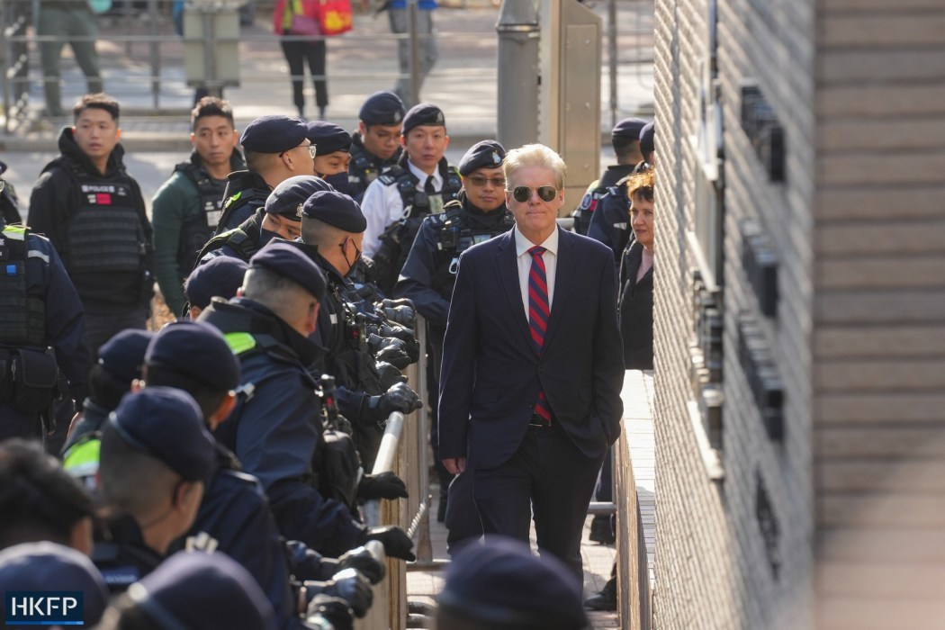 Consulate officials arrive at the West Kowloon Law Courts Building on February 9, 2026, to witness the sentencing of pro-democracy media tycoon Jimmy Lai. Photo: Kyle Lam/HKFP.