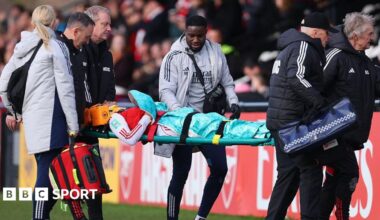 Olivia Smith is carried off the pitch on a stretcher