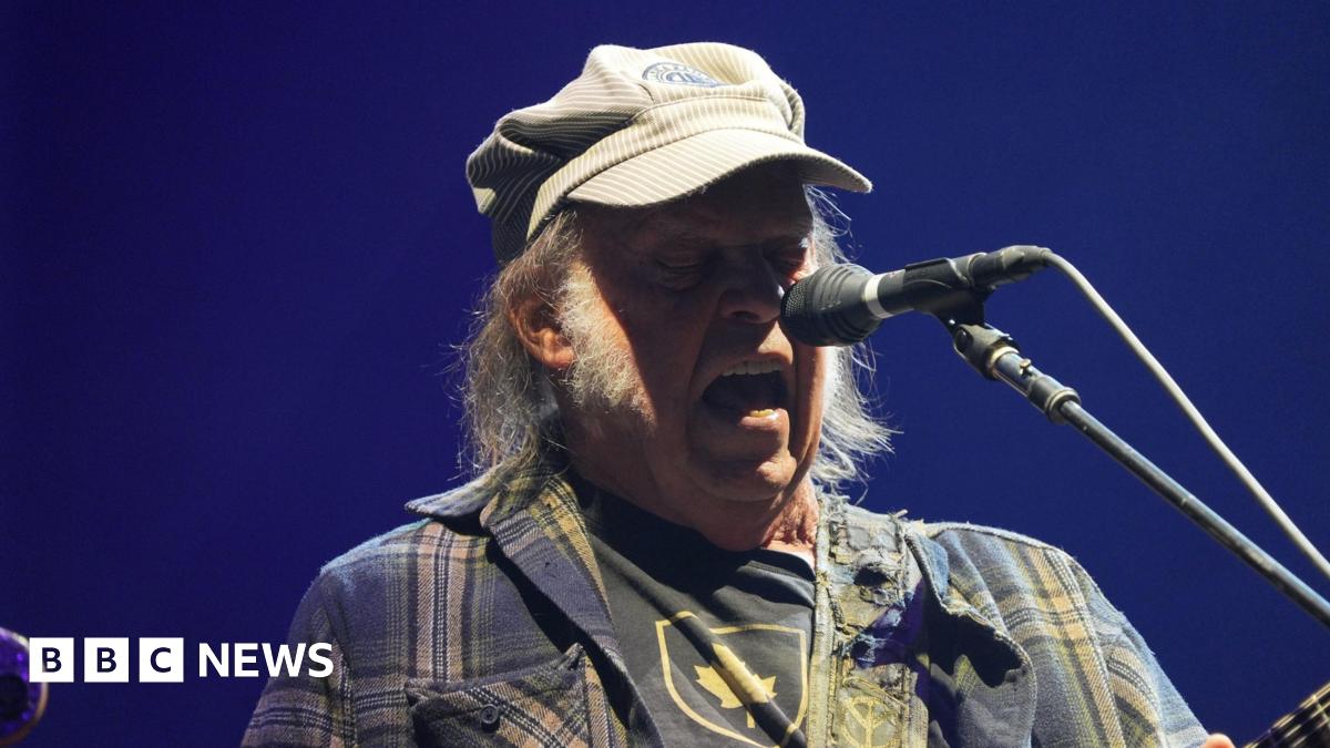 Neil Young singing into a microphone.