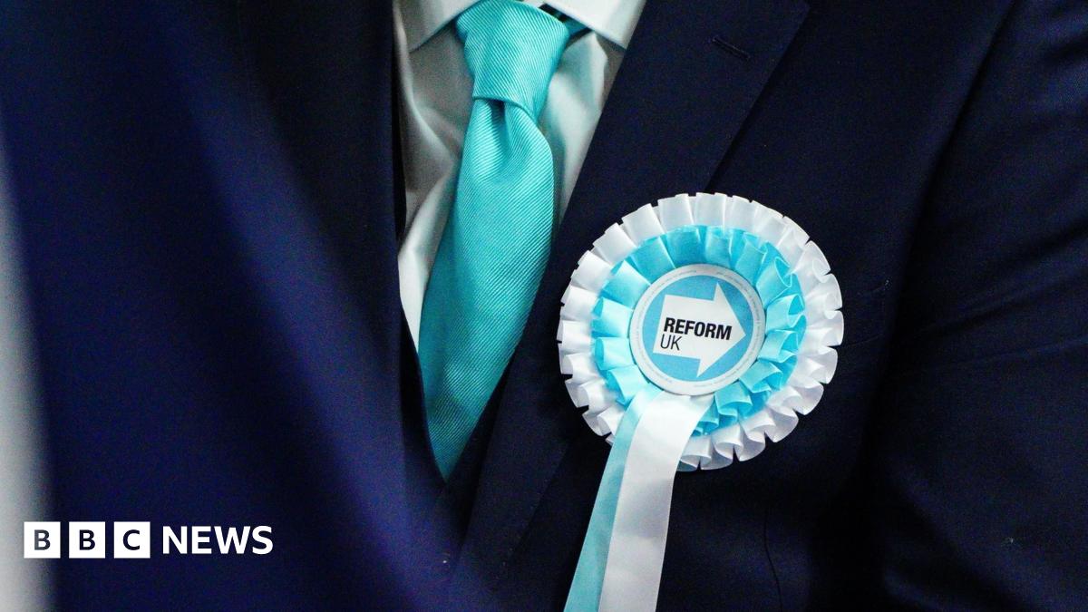 Jason O'Connell, wearing a blue suit, white shirt and burgundy tie. He has short brown hair and is clean shaven. He is seen in BBC Politics Wales' TV studio during a debate on Sunday