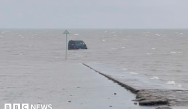 van in the distance in the middle of the sea