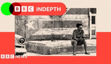 People walk past rubbish piled up on a street in Havana