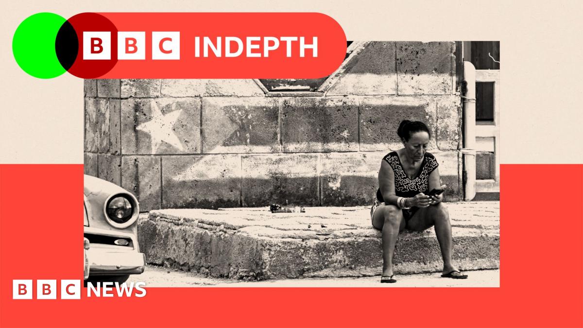 People walk past rubbish piled up on a street in Havana