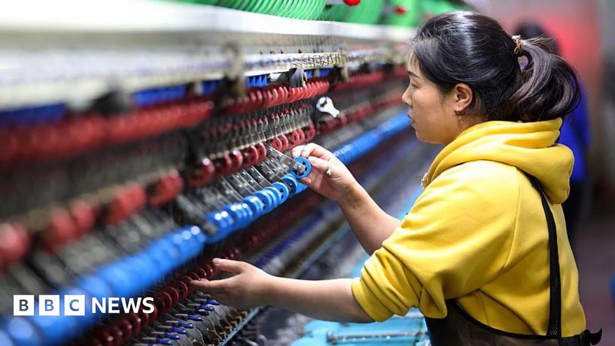 An employee operates a machine at a silk production enterprise on November 17, 2025 in Chongqing, China