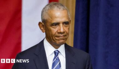 A headshot of Barack Obama against a black background
