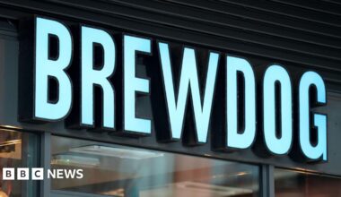 A Brewdog sign above a bar in blue lettering.