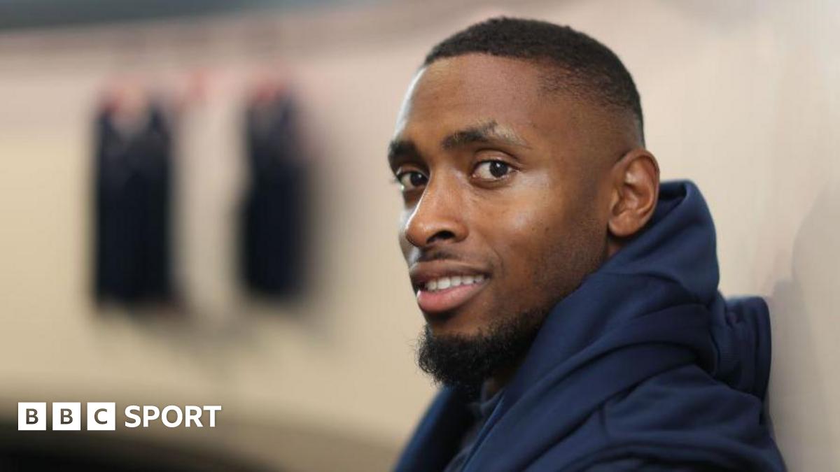 Joel Fearon smiles while wearing his training kit