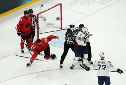 Feb 15, 2026; Milan, Italy; Tom Wilson of Canada clashes with Pierre Crinon of France in men's ice hockey group A play during the Milano Cortina 2026 Olympic Winter Games at Milano Santagiulia Ice Hockey Arena. Mandatory Credit: Mike Segar/Reuters via Imagn Images