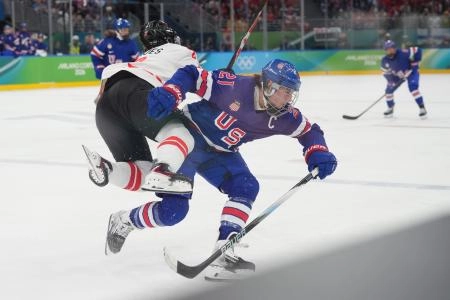 Feb 19, 2026; Milan, Italy; Sophie Jaques (2) of Canada runs into Hilary Knight (21) of the United States in the women's ice hockey gold medal game during the Milano Cortina 2026 Olympic Winter Games at Milano Santagiulia Ice Hockey Arena. Mandatory Credit: Amber Searls-Imagn Images