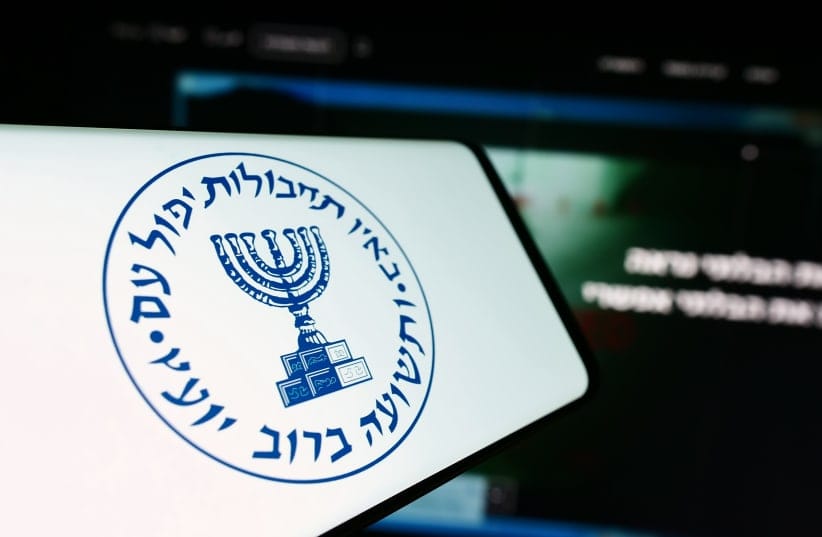   Smartphone with logo of Israeli national intelligence agency Mossad in front of website. 