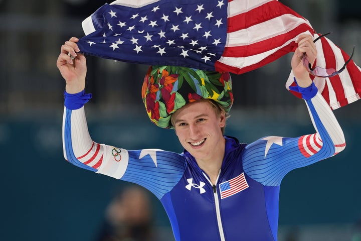 Jordan Stolz invokes flower power by putting on a hat made for winners by a fan.