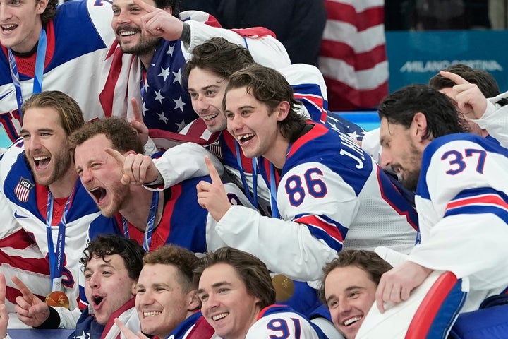 The U.S. men's ice hockey team poses for a photo after defeating Canada for a gold medal at the Winter Olympics in Milan on Sunday.