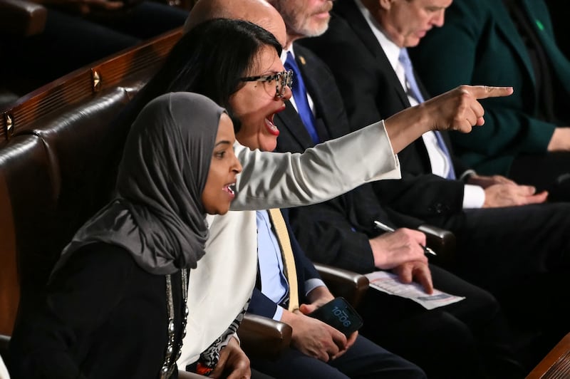U.S. Representatives Ilhan Omar, Democrat from Minnesota, and Rashida Tlaib, Democrat from Michigan, shout as President Donald Trump delivers the State of the Union address in the House Chamber of the US Capitol in Washington, DC, on February 24, 2026.