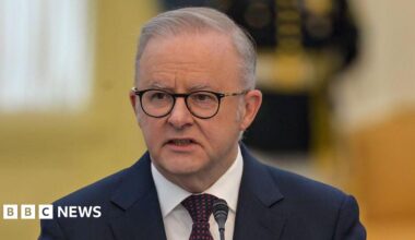 Anthony Albanese wearing a navy suit and red and navy tie