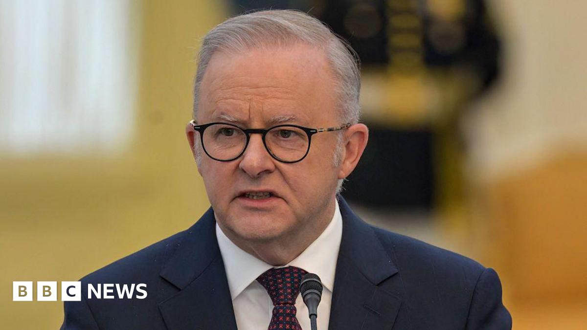 Anthony Albanese wearing a navy suit and red and navy tie