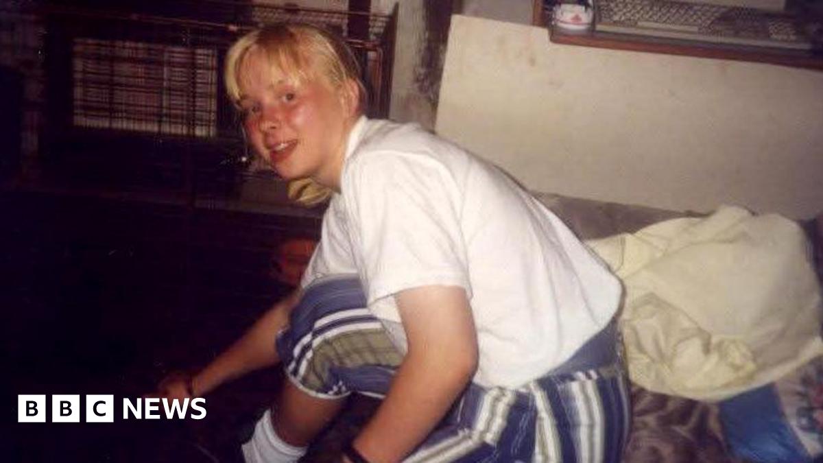 Faded photo of a teenage girl sitting on a sofa in a living room, with a gas fire in the background.