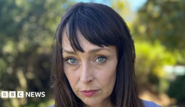 Juliette Bryant, now aged 43, has long brown hair with a fringe and stands outside with a serious expression