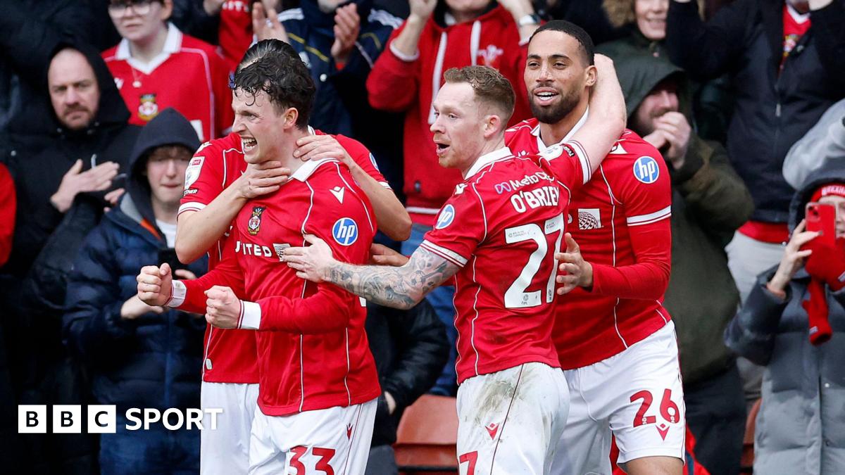 Wrexham goal scorer Nathan Broadhead (second left) celebrates with Lewis O'Brien and Zak Vyner (right)