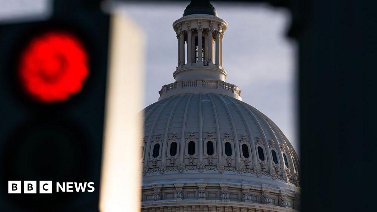 A red street light seen next to the US Capitol Dome at Congress