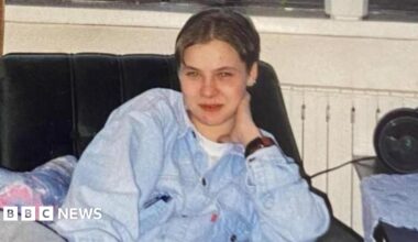 An aerial photo showing a sea of flooded fields in Somerset and in the foreground is a hill with a church on the top
