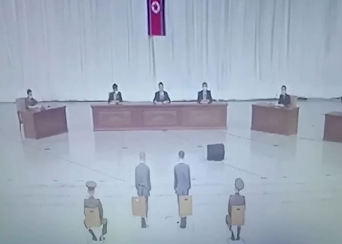 North Korea public e*******n scene with seated officials and citizens accused of watching Squid Game.