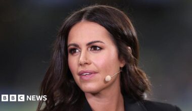 A close-up of Mason, a dark haired woman looks off camera with a microphone mouthpiece coming out from behind her ear