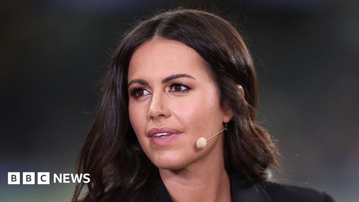 A close-up of Mason, a dark haired woman looks off camera with a microphone mouthpiece coming out from behind her ear