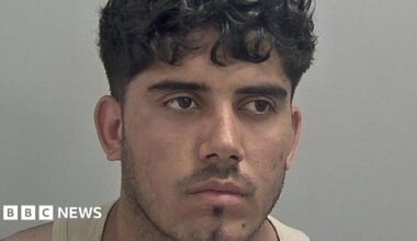 Mugshot of Ahmed Mulakhil, wearing a beige vest.