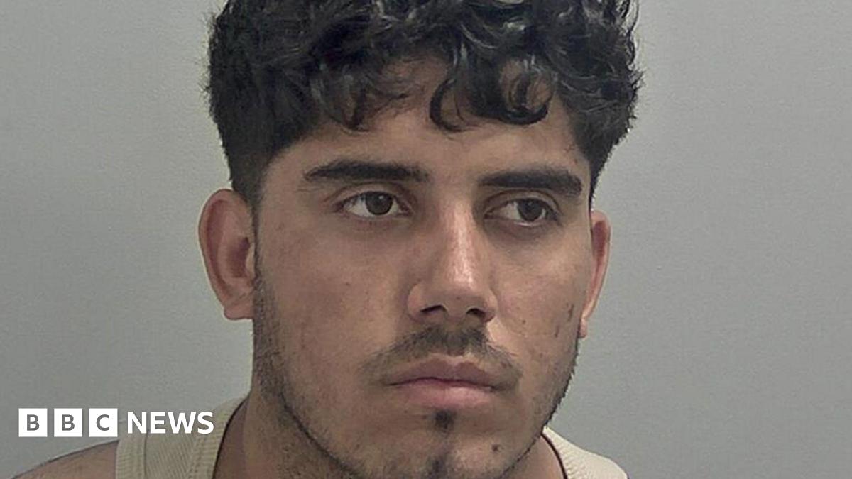 Mugshot of Ahmed Mulakhil, wearing a beige vest.