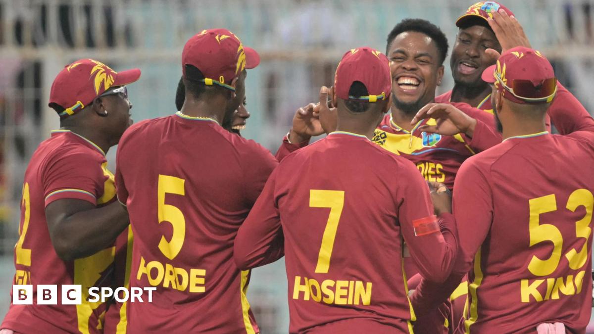 West Indies' Shimron Hetmyer (3R) celebrates with teammates after taking the wicket of Scotland's George Munsey