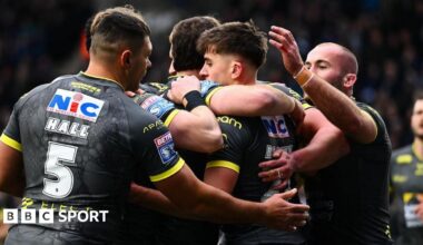Leeds Rhinos player George Brown is congratulated by team-mates after scoring a try against Widnes Vikings.