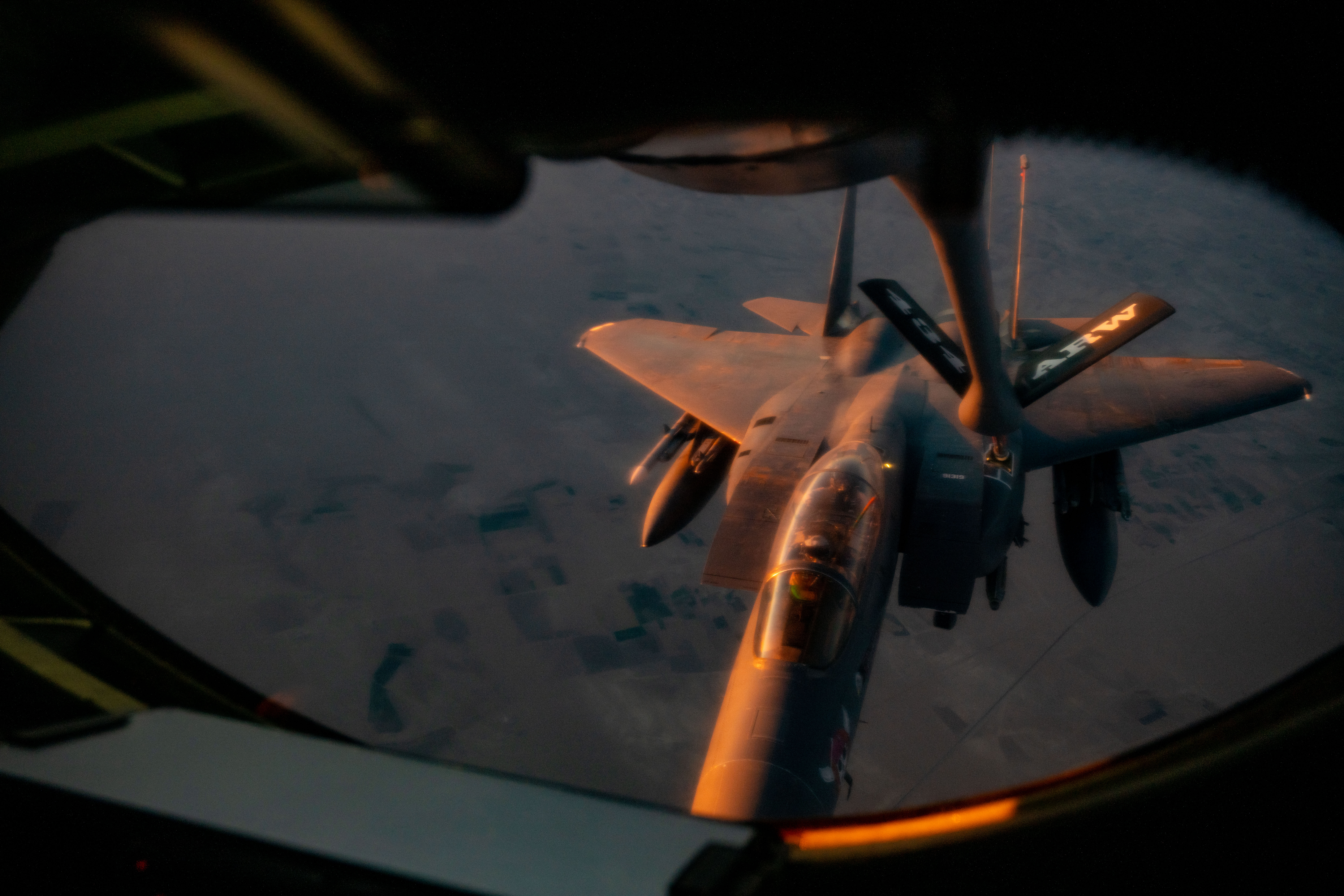 A U.S. Air Force F-15E Strike Eagle aircraft assigned to the 391st Expeditionary Fighter Squadron refuels from a KC-135 Stratotanker aircraft boom over the U.S. Central Command area of responsibility, Oct. 29, 2025. Aerial refueling allows aircraft to extend their combat range and loiter time, allowing them to remain airborne for longer periods and remain effective throughout the CENTCOM AOR. (U.S. Air Force photo by Tech. Sgt. Nicholas Monteleone)