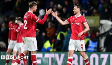 Wrexham's Dominic Hyam celebrates with team-mate Callum Doyle at the final whistle during the Emirates FA Cup Fourth Round match between Wrexham and Ipswich Town